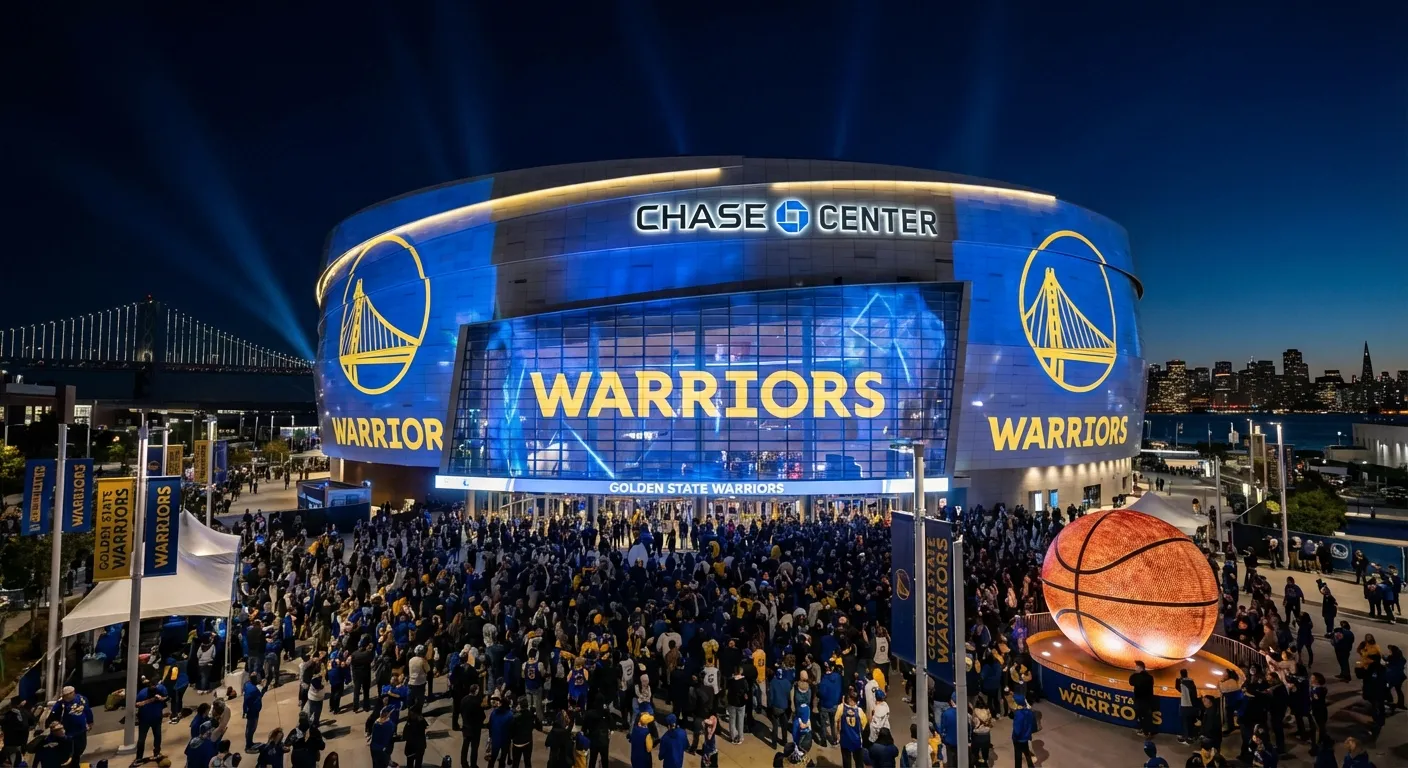 Chase Center exterior with Warriors championship banners visible at night