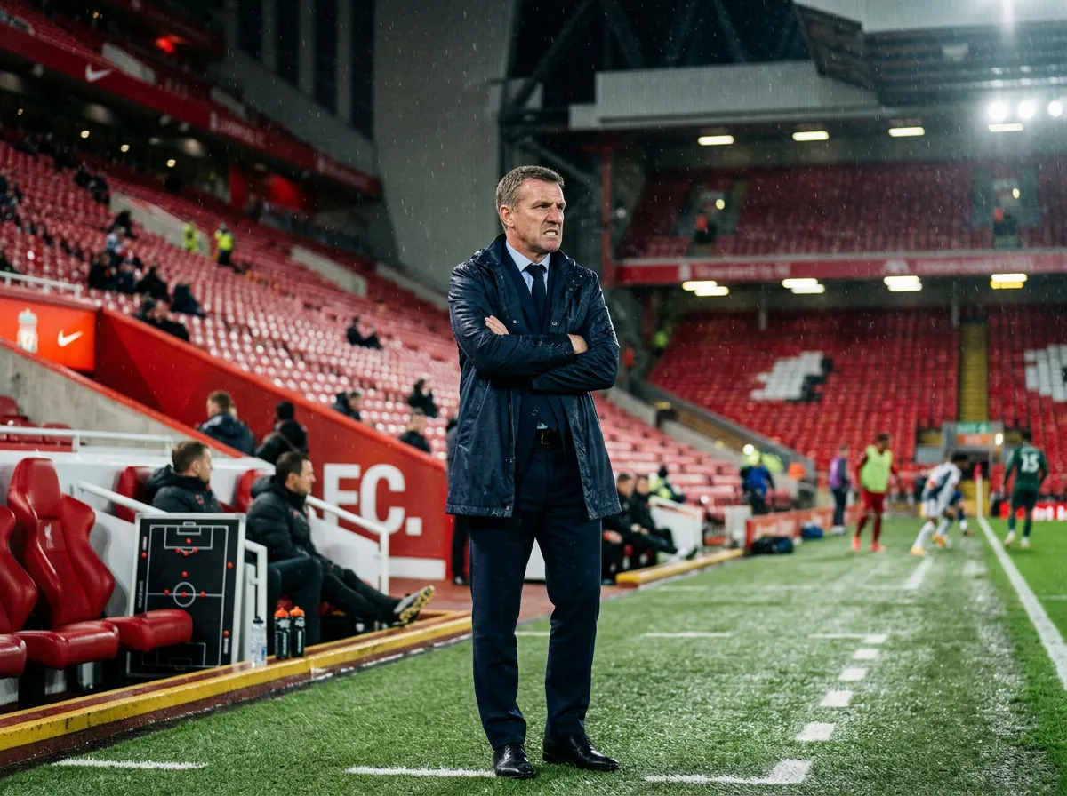 Liverpool manager standing alone on the touchline with arms folded looking concerned