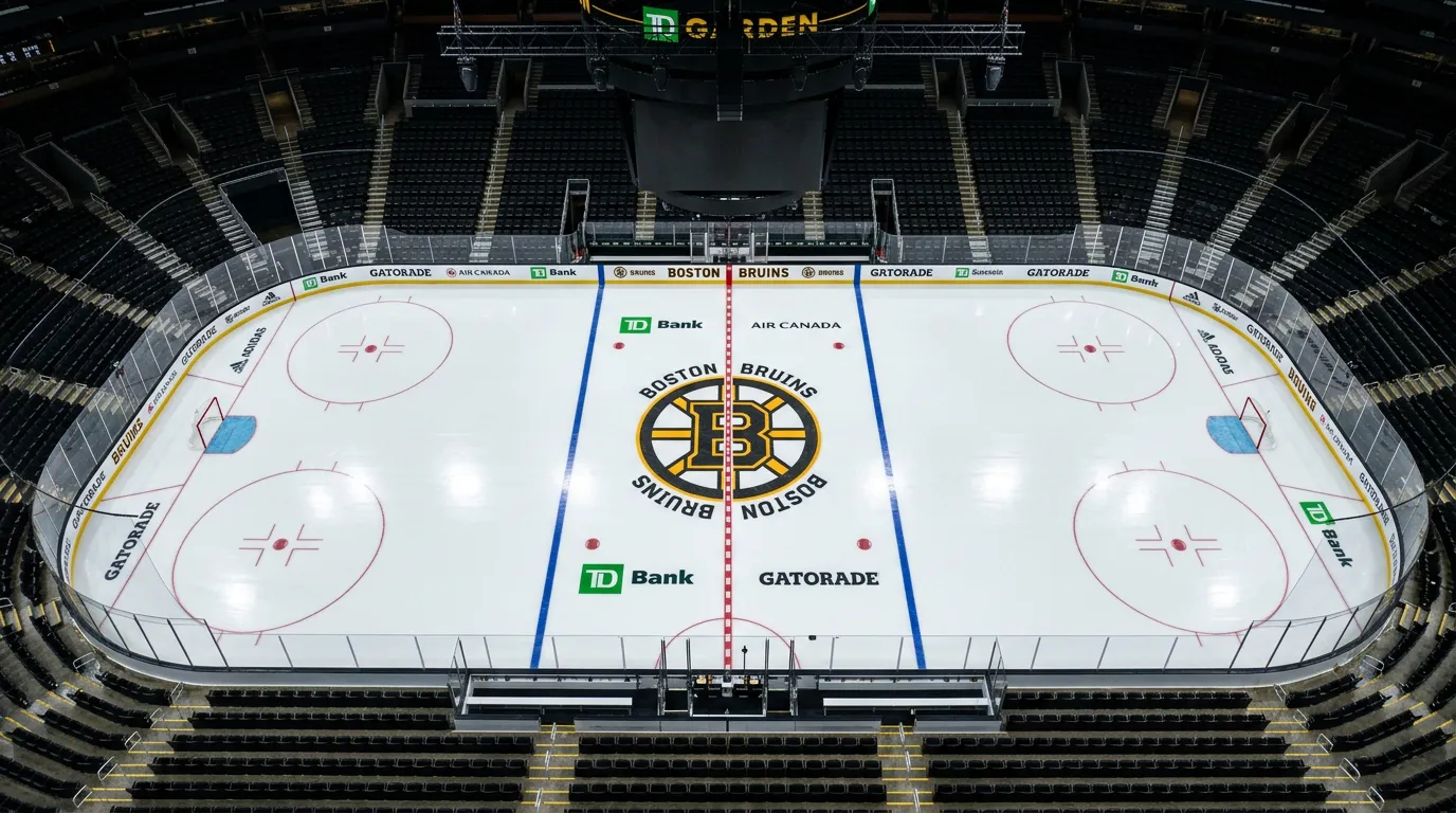 NHL arena ice surface being prepared with team logos visible at center ice